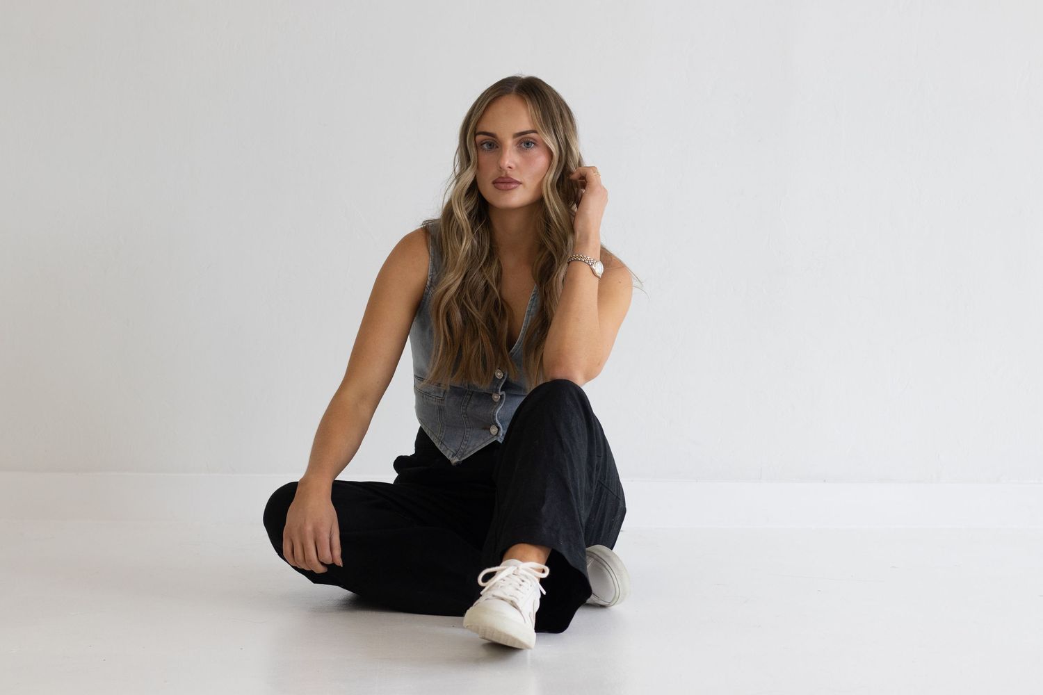 Casual style photo with denim and gray vest against white background.