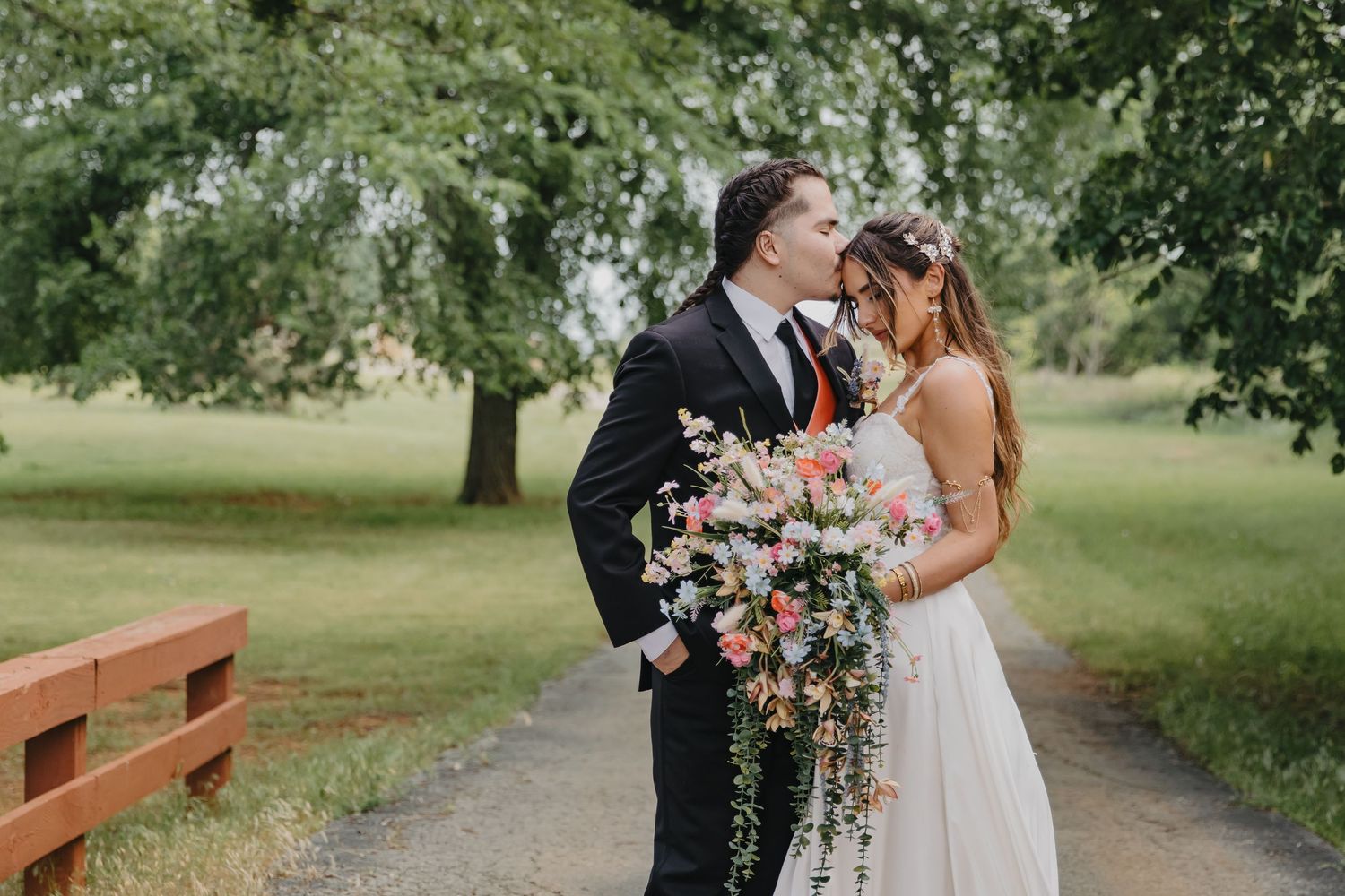 A joyful wedding moment captured outdoors with a beautiful floral bouquet.