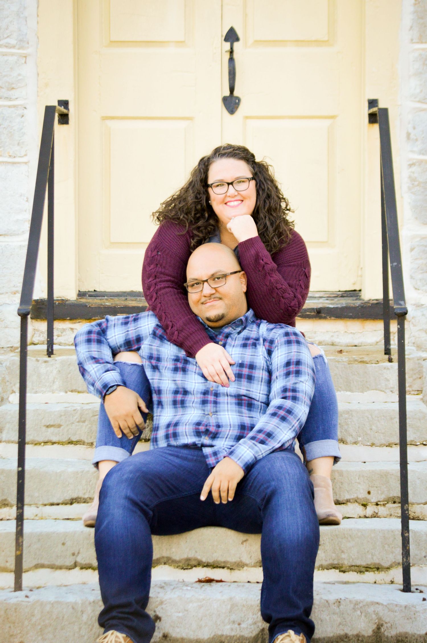 A newly engaged couple embrace one another in celebration of their big day ahead.