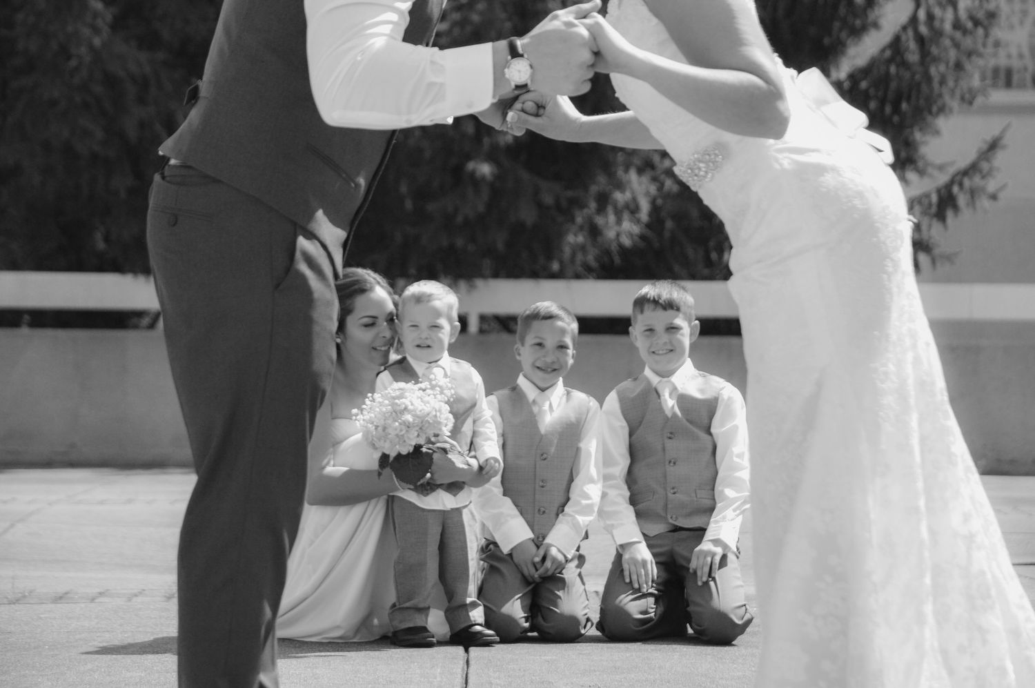Bride and Groom share a loving kiss after tying the knot to officially blend their families.