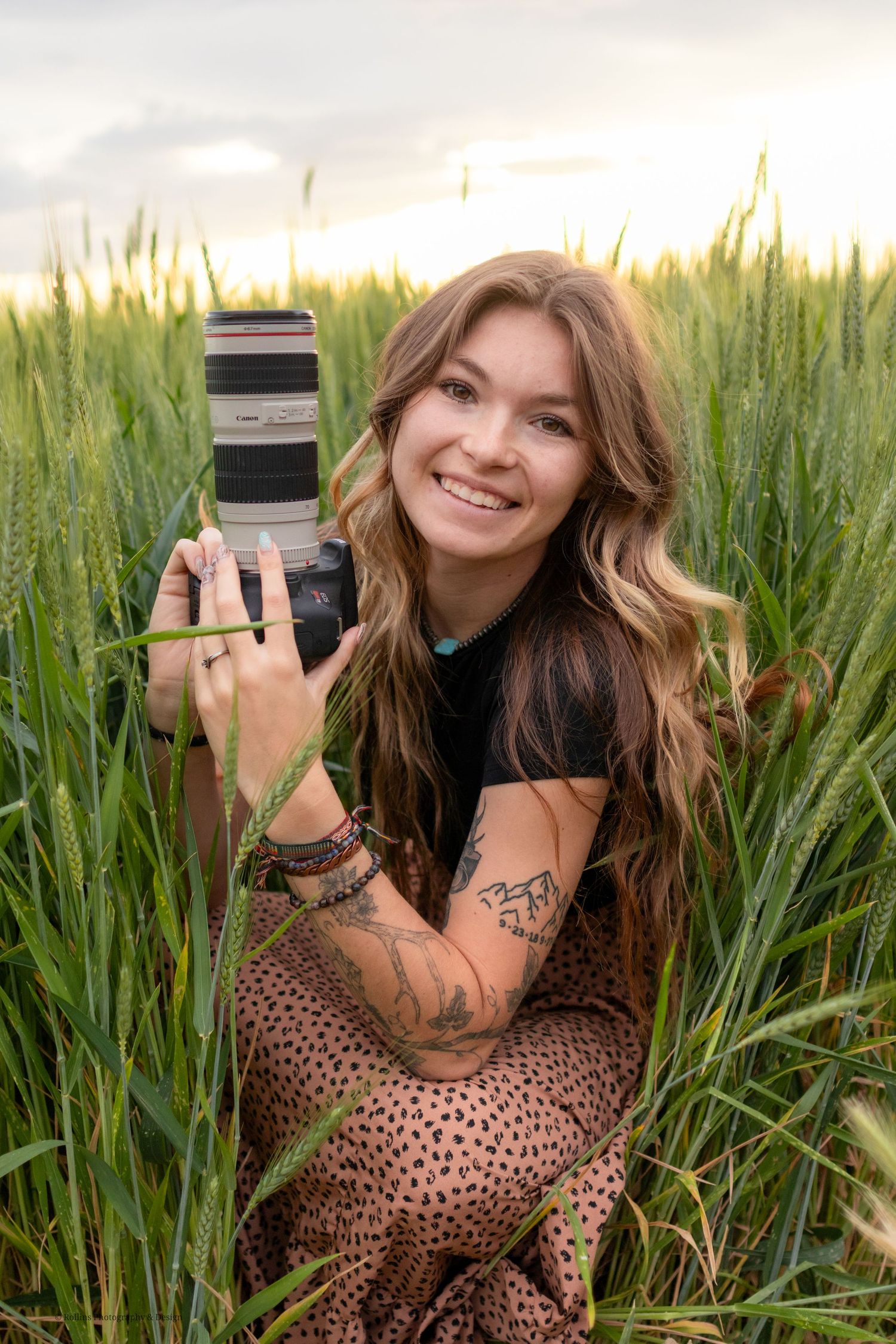 in the grass a photographer holding her camrea