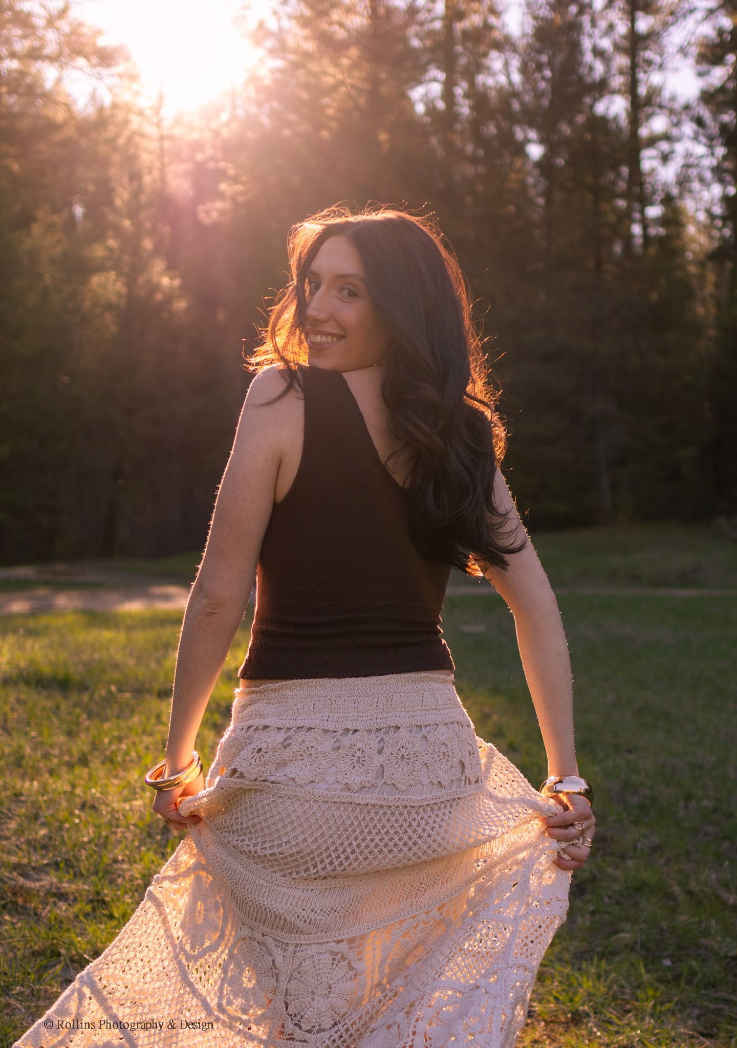 Senior running into the trees during golden hour
