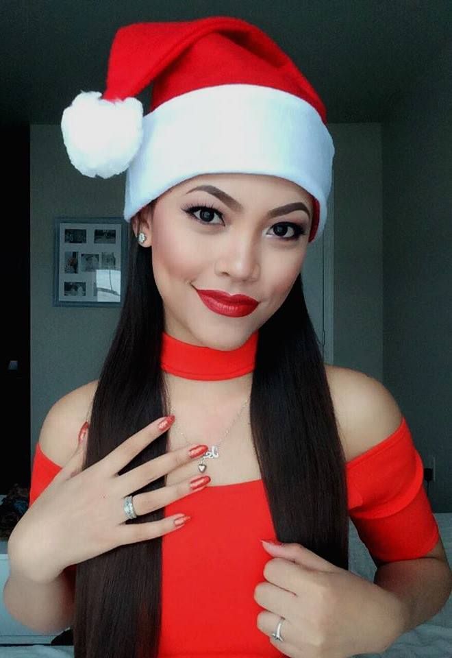 Festive holiday portrait with Santa hat and red outfit showcasing sparkly manicure.