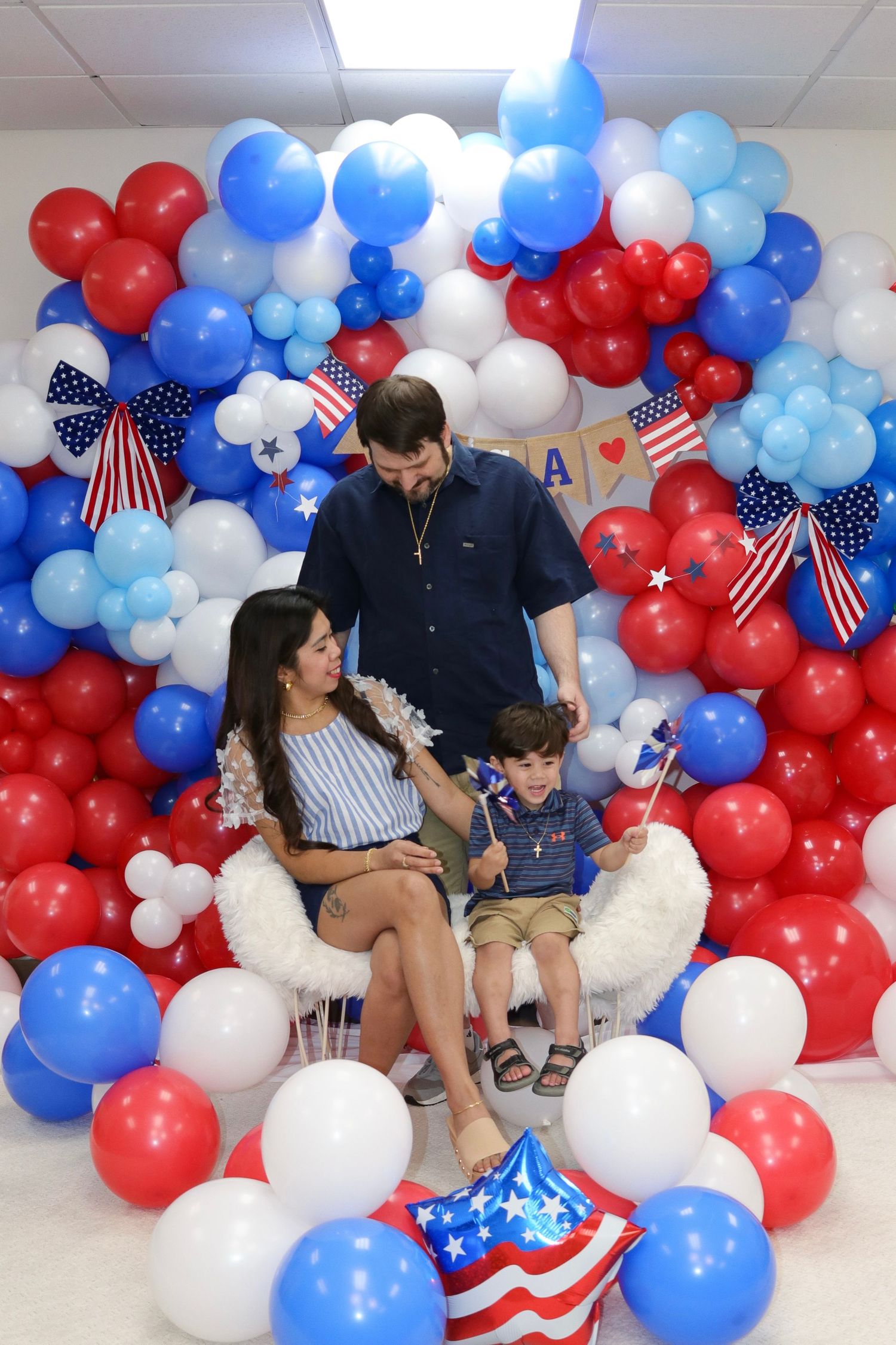 Patriotic balloon arch display with red white and blue balloons and USA decorations.