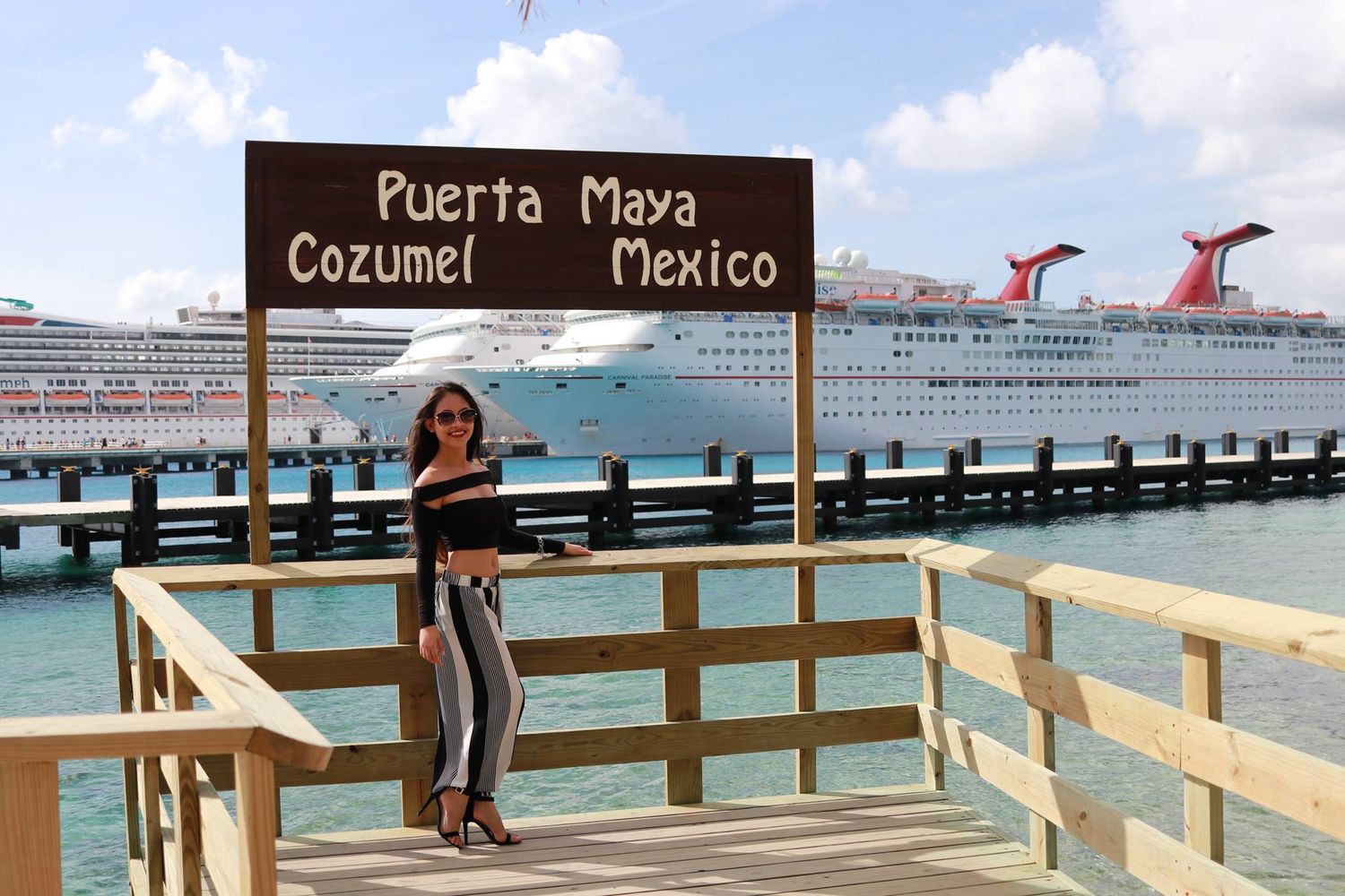 Tourist photo at Puerta Maya cruise port in Cozumel with ships visible in background.