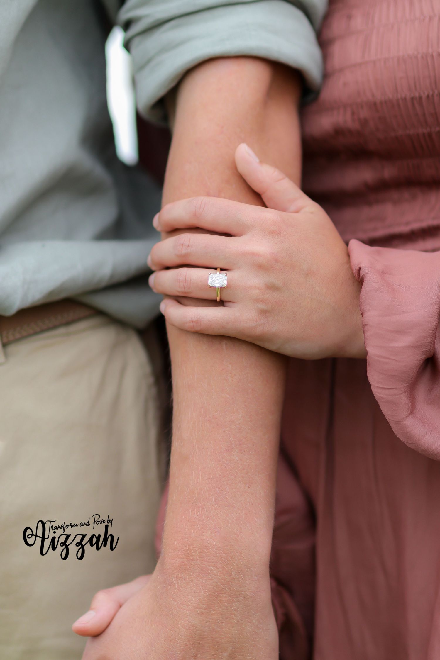 Close-up of hands with engagement ring showing gentle touch between couple.