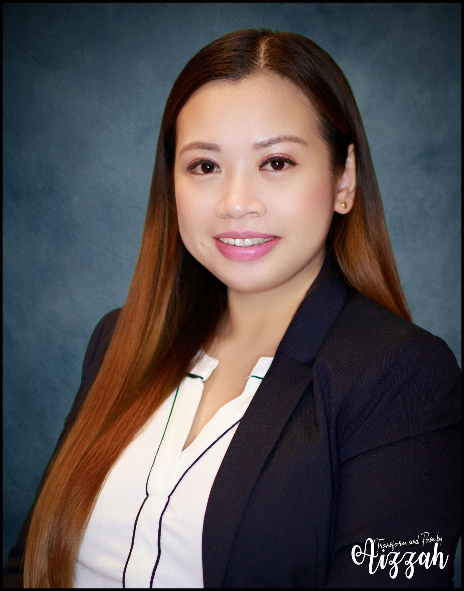 Professional portrait of person in black blazer and white blouse against dark background.