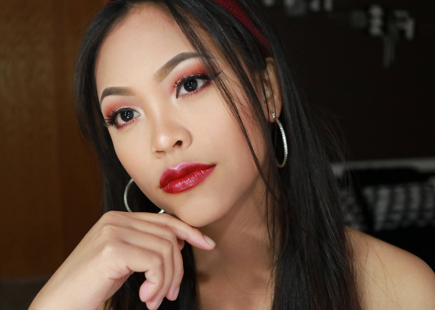 Glamour beauty portrait with classic red lipstick and sleek dark hair.
