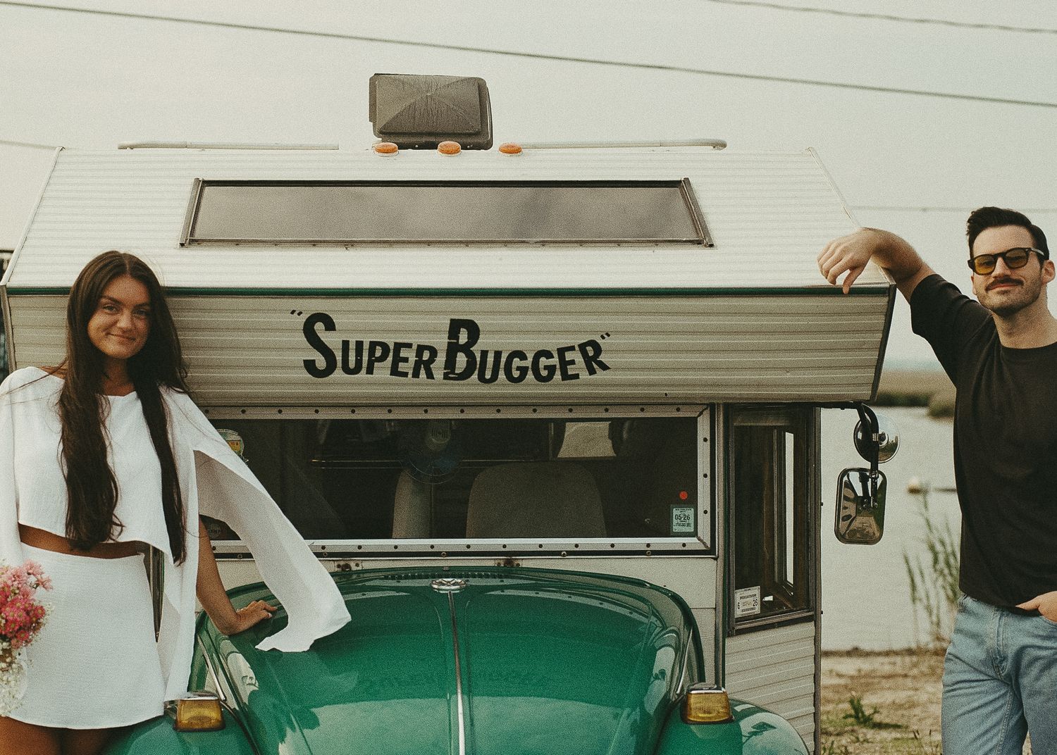 Vintage Super Bugger camper van parked with classic white and green exterior.