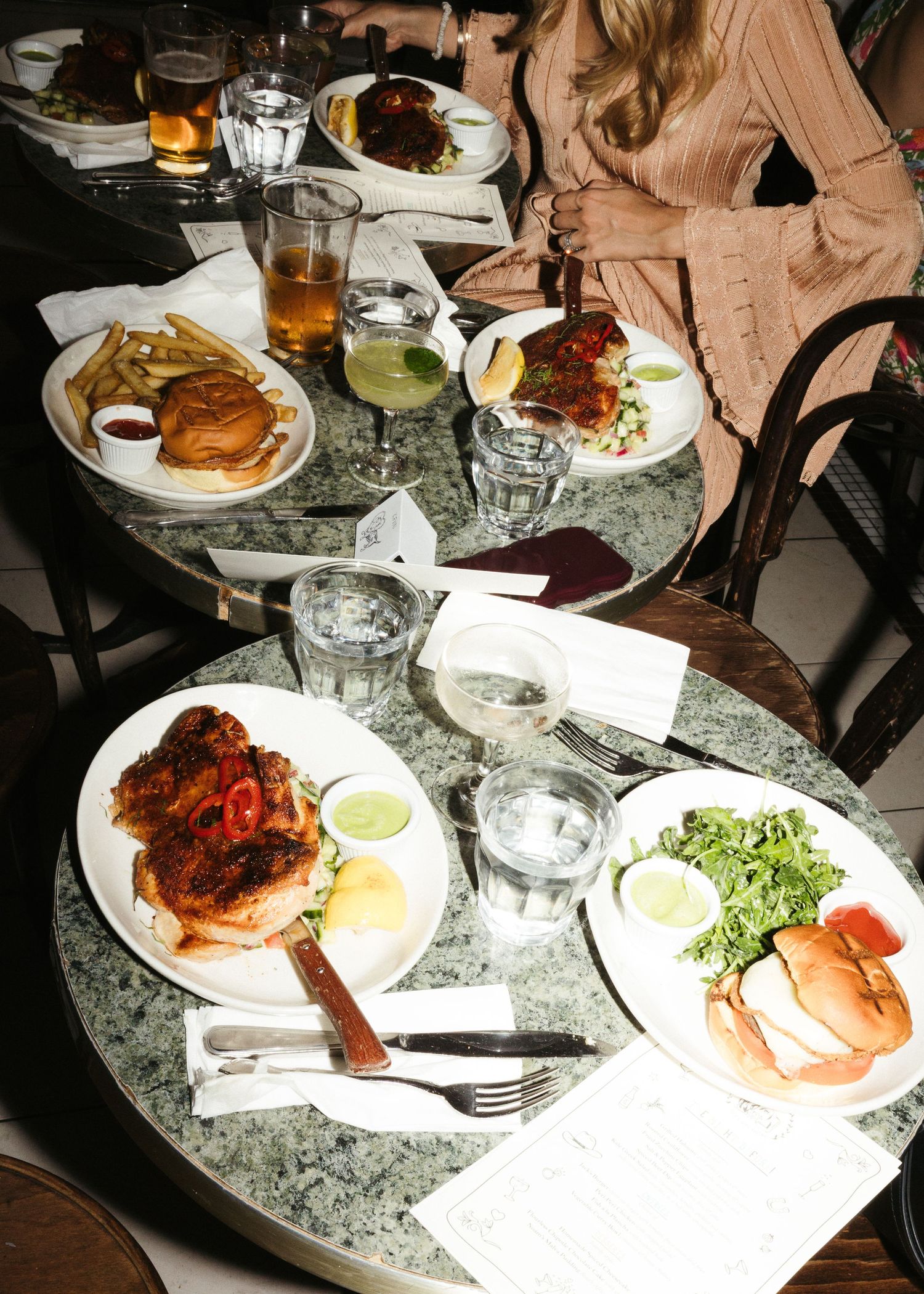Overhead view of restaurant table with good food and cocktails.