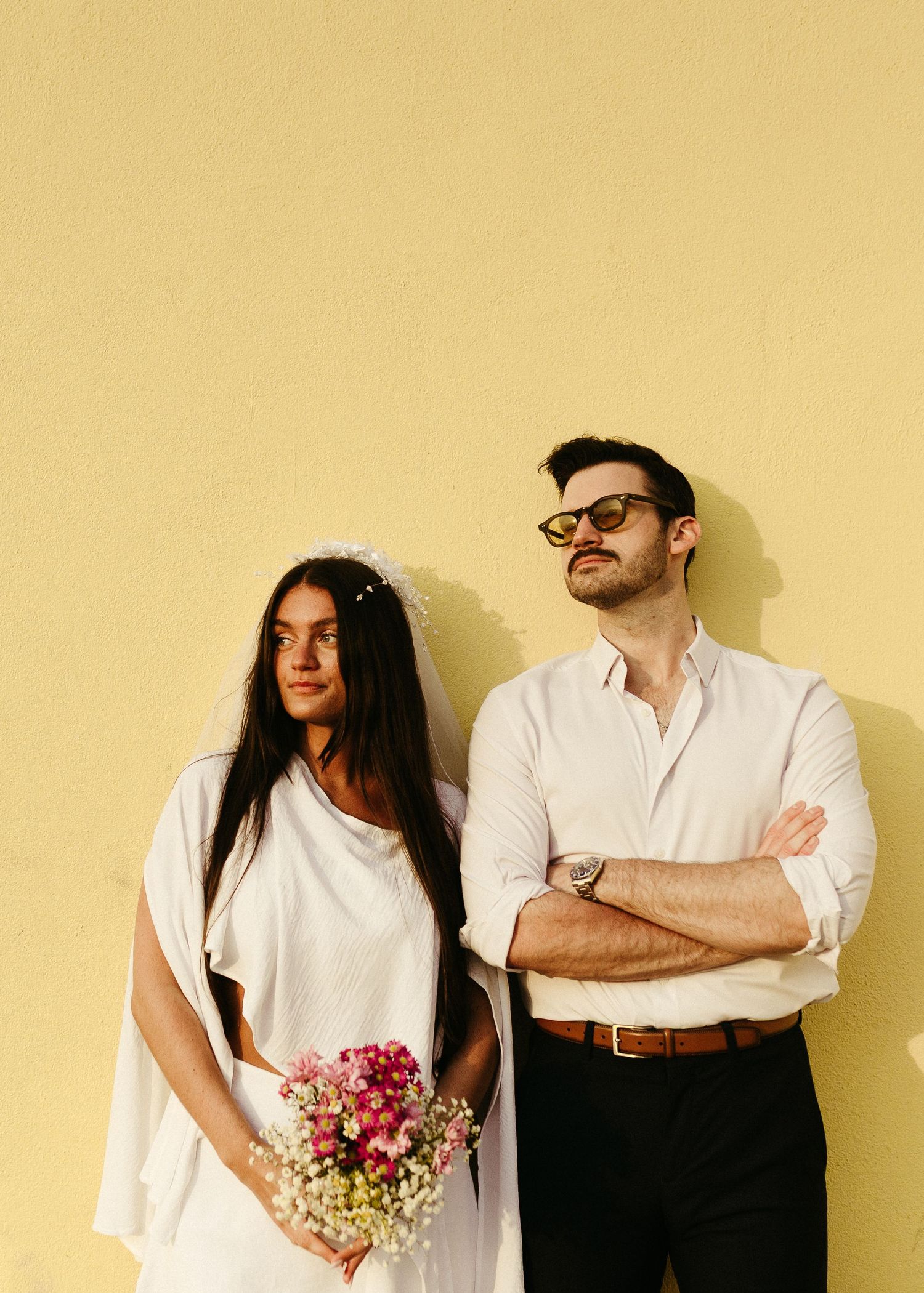 An artistic overhead black and white portrait of a wedding couple against white background.