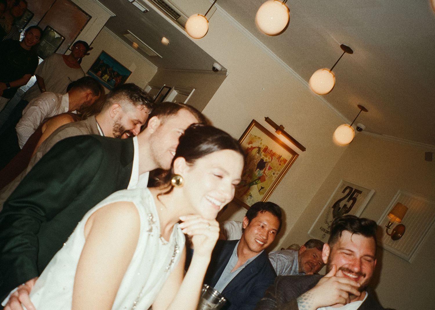 People enjoying themselves at a lively indoor celebration, captured on 120 film with a Holga 120.