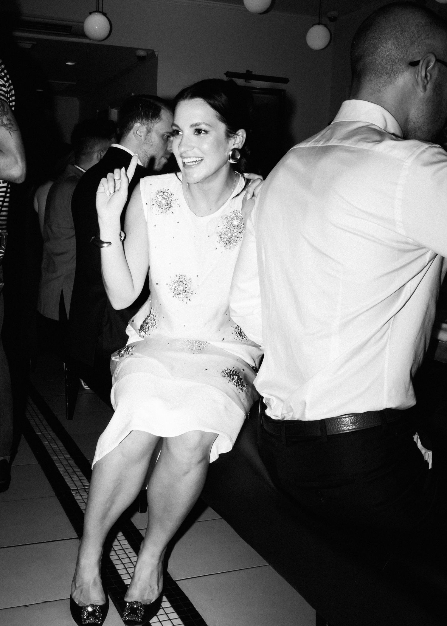 Black and white photo of an elegant dinner party scene.