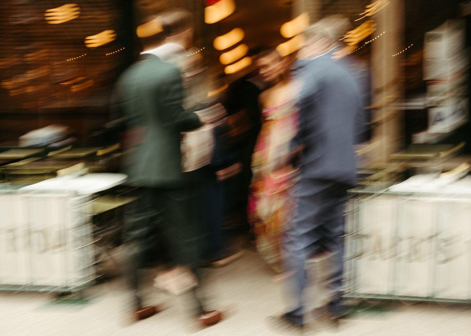 Blurred motion shot of people walking outside an establishment.