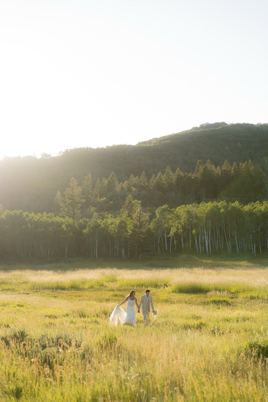 Bride and groom in Utah wedding photographed by Jensen Photo & Film. Mountain wedding backdrop