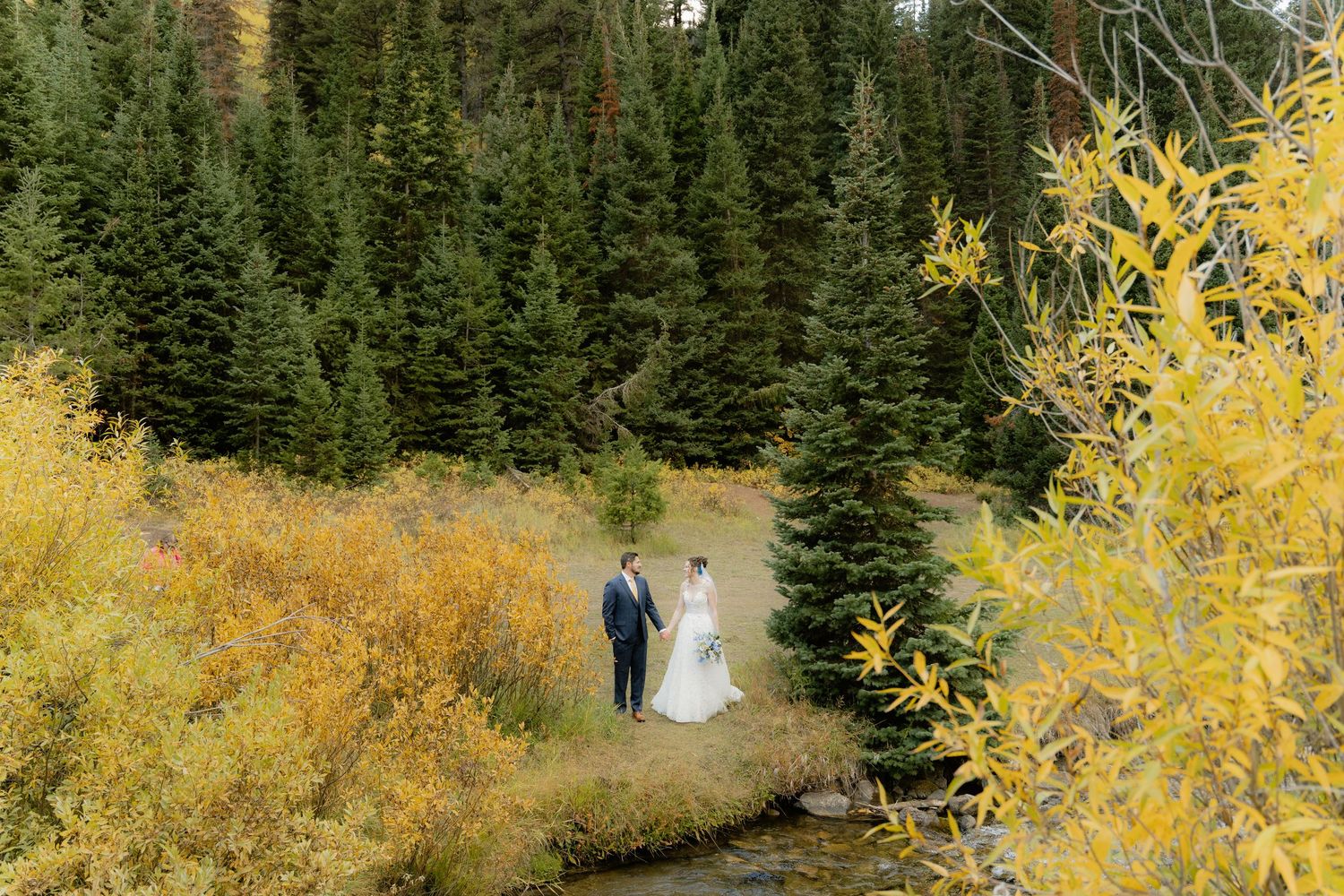 Bride and groom in Utah wedding photographed by Jensen Photo & Film. Mountain wedding backdrop