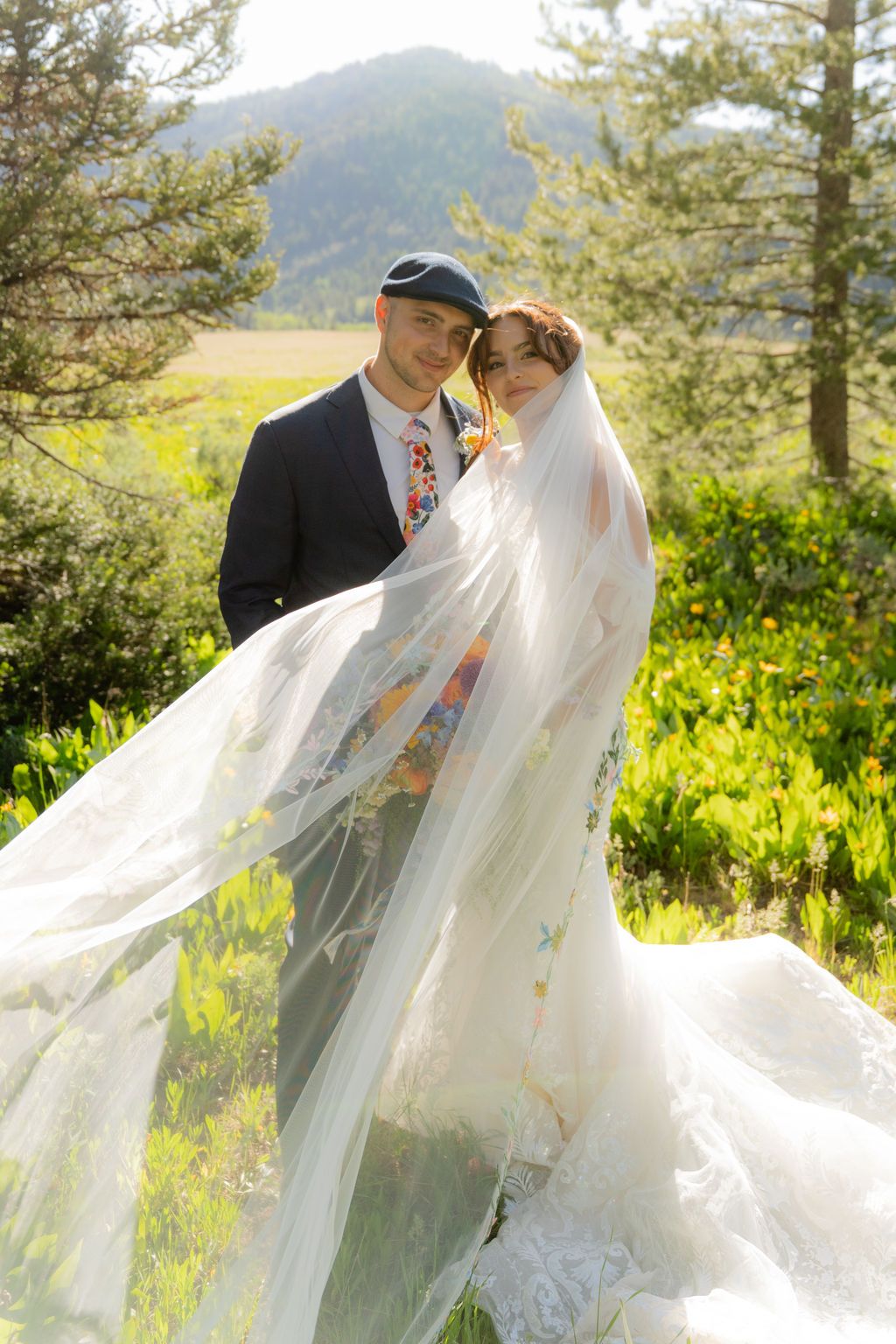 Wedding couple at Beaver Creek Lodge taking portraits with veil flowing in the wind