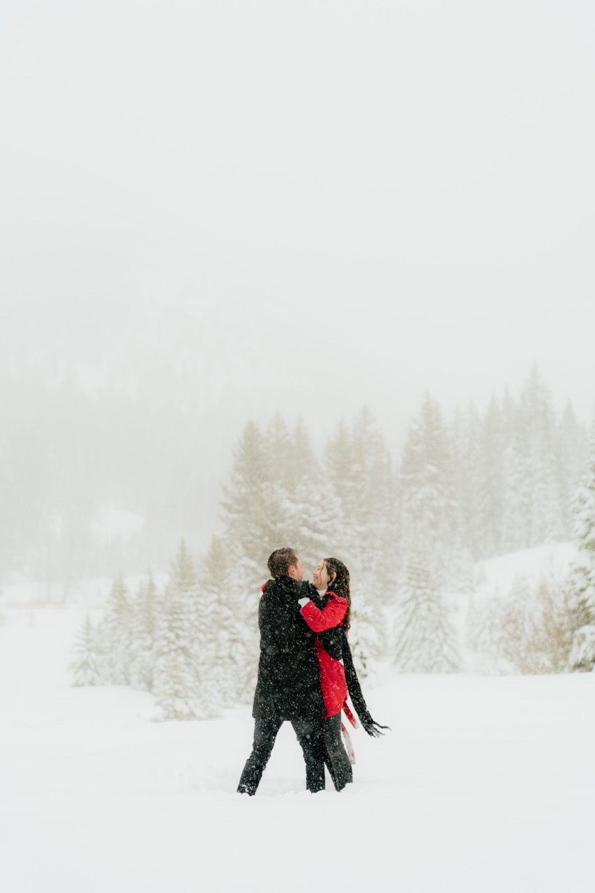 Couple during a snowy winter engagement photoshoot in Salt Lake City, Utah photographed by Jensen Photo & Film