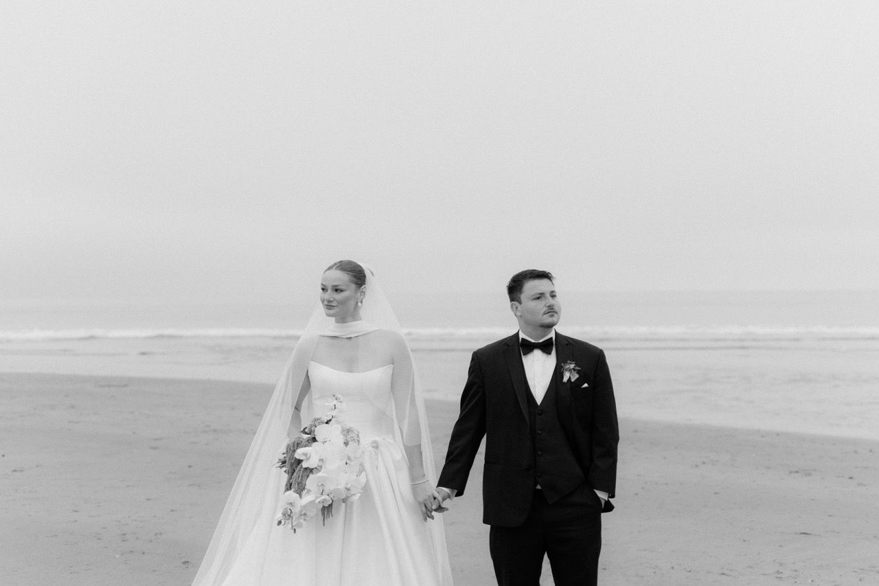 Black and white image of wedding couple on the beach at Avila Beach, California