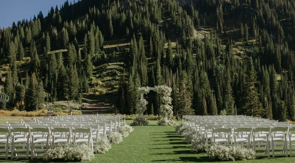 Wedding at Snowpine Lodge in Alta, Utah. Includes a full floral arch and wedding ceremony mountain backdrop