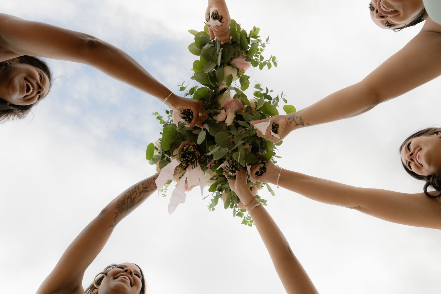 Creative image of bridal party holding bouquets in Utah wedding photographed by Jensen Photo & Film