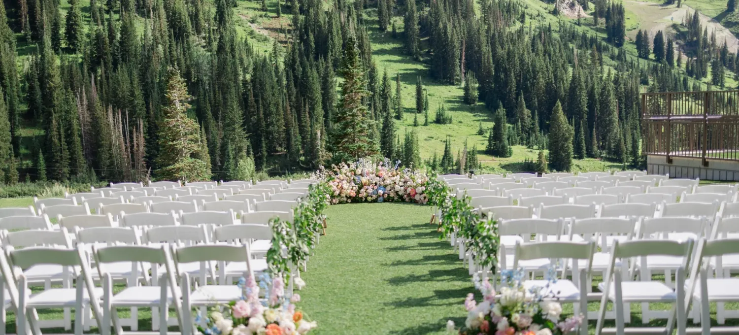 Wedding at Snowpine Lodge in Alta, Utah. Includes a full floral arch and wedding ceremony mountain backdrop