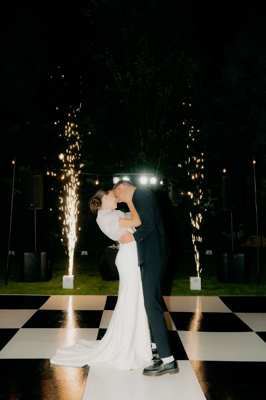 Bride and groom in Utah wedding photographed by Jensen Photo & Film. First dance flash photography with fireworks.