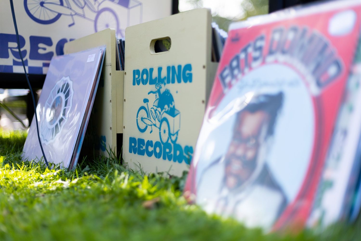 Record shop signage displayed on banners at an outdoor festival setup.