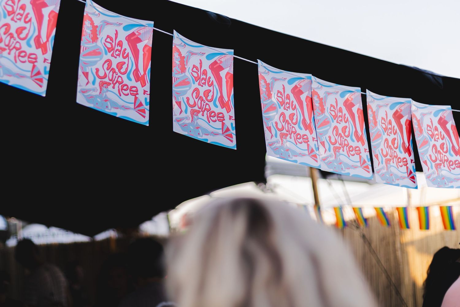 Decorative red and white patterned banners strung across an outdoor venue.