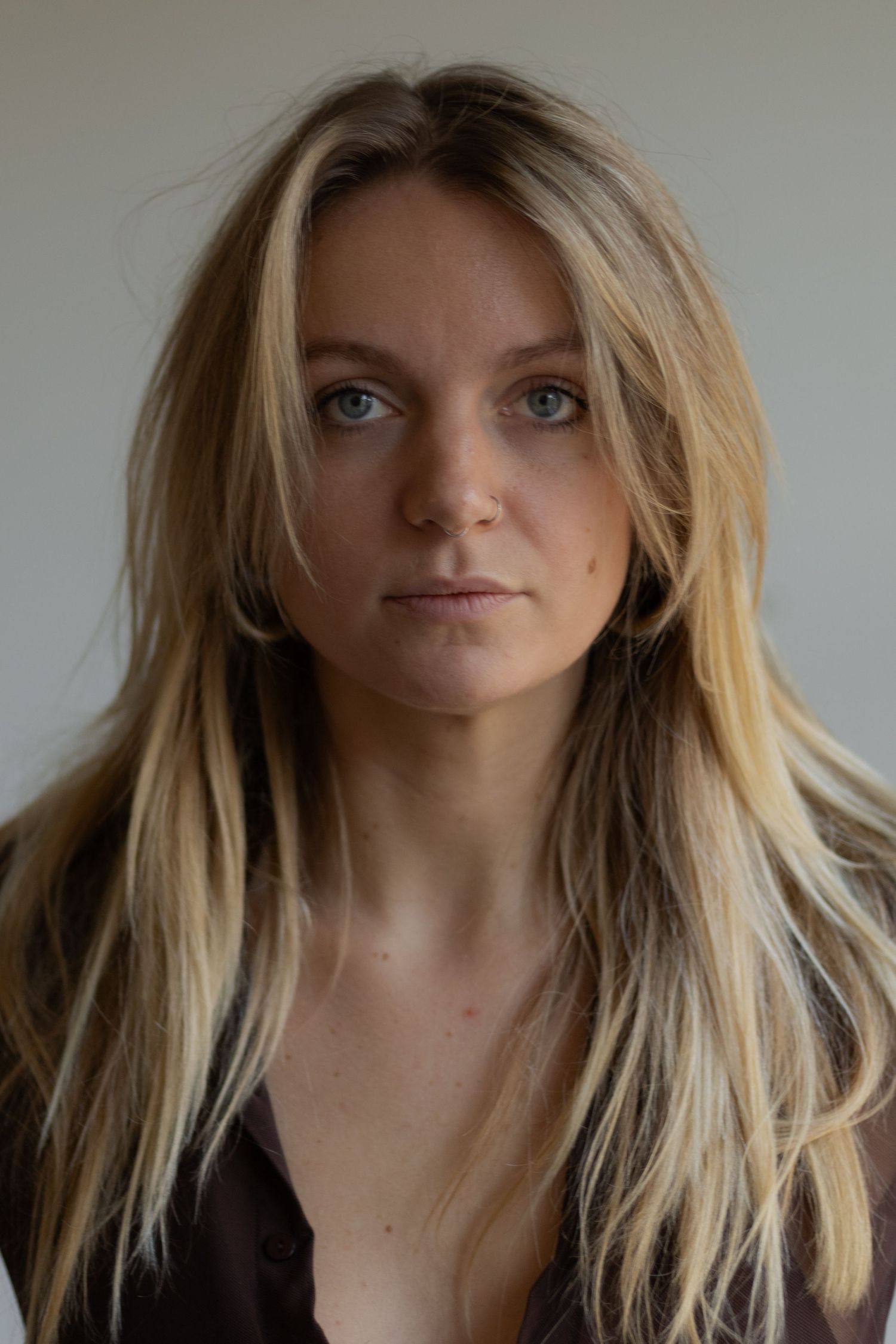Portrait series with blonde hair against simple grey background.