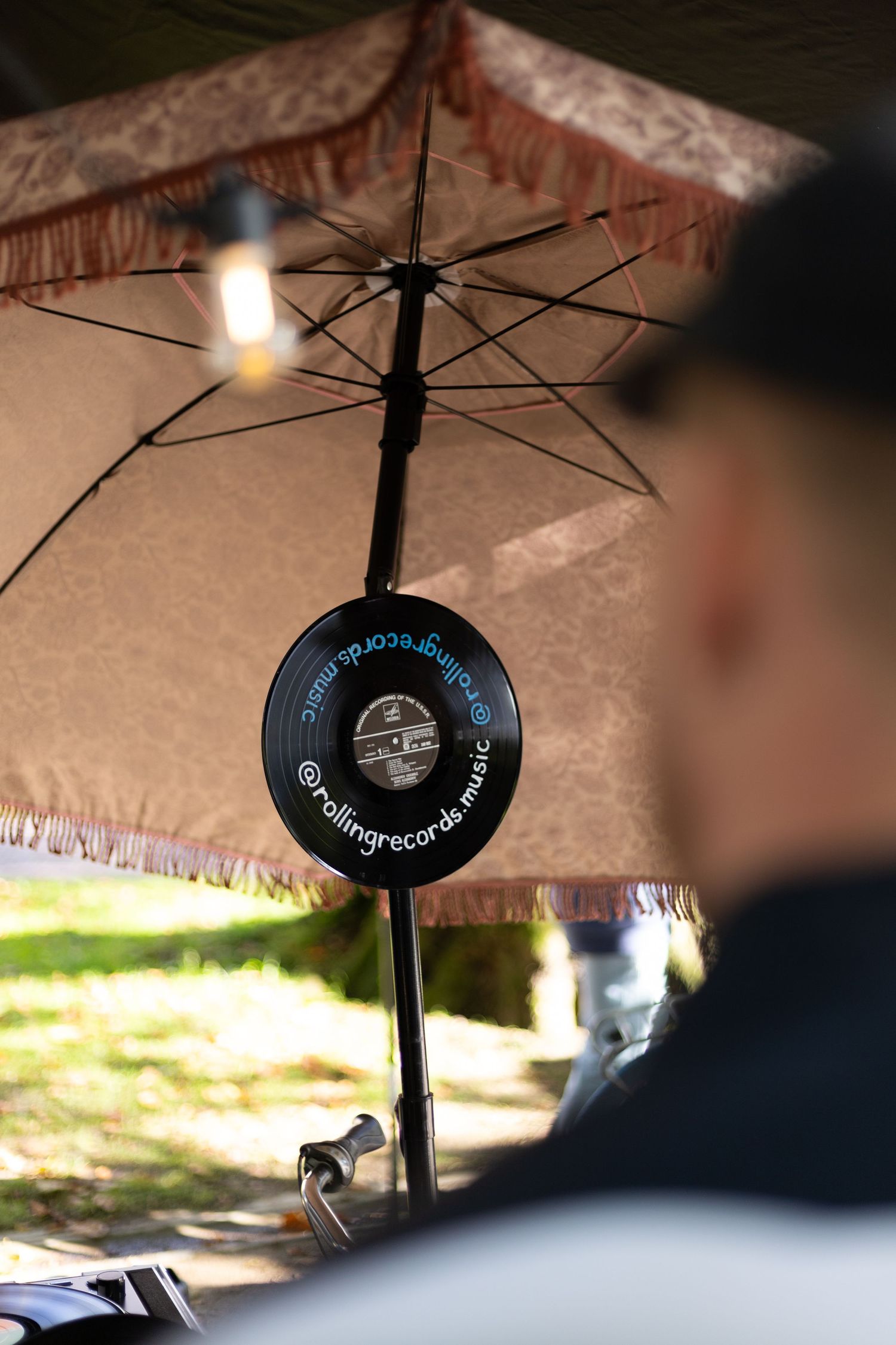 Close-up of umbrella style ring lights creating a decorative lighting effect under a cloth canopy.