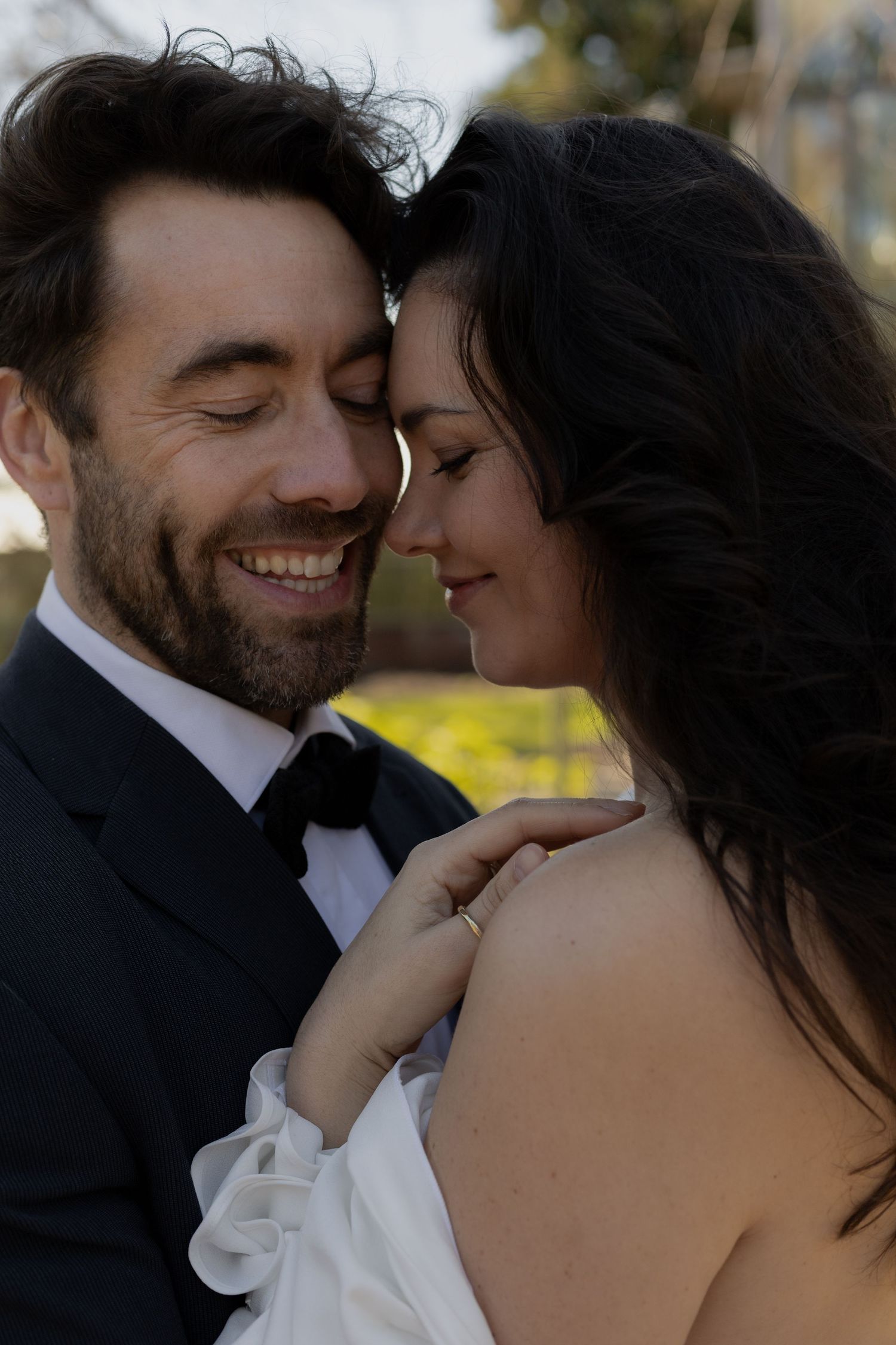 Intimate close-up of a couple sharing a joyful moment on their wedding day.