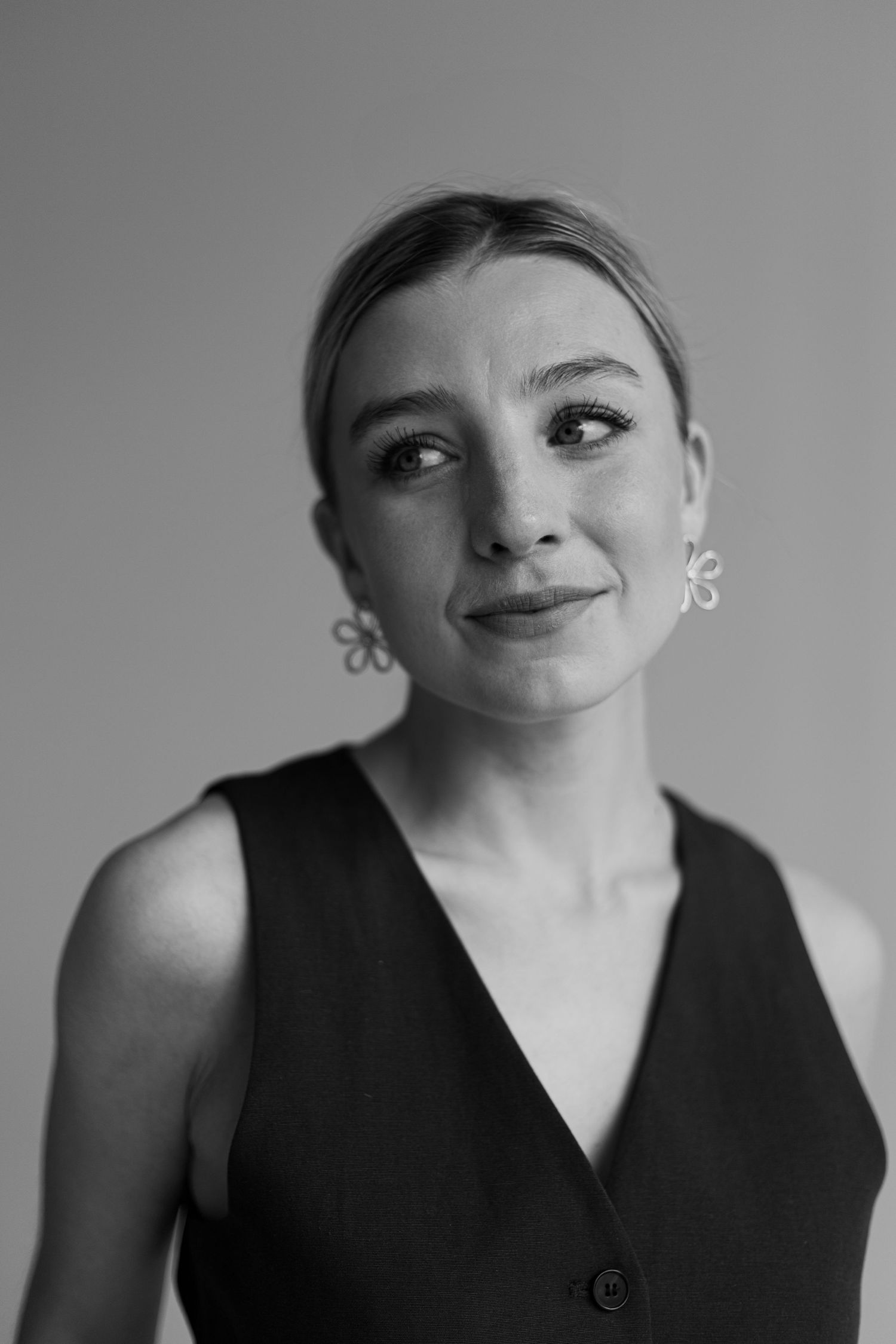 Black and white portrait series showing expressive poses in sleeveless top.