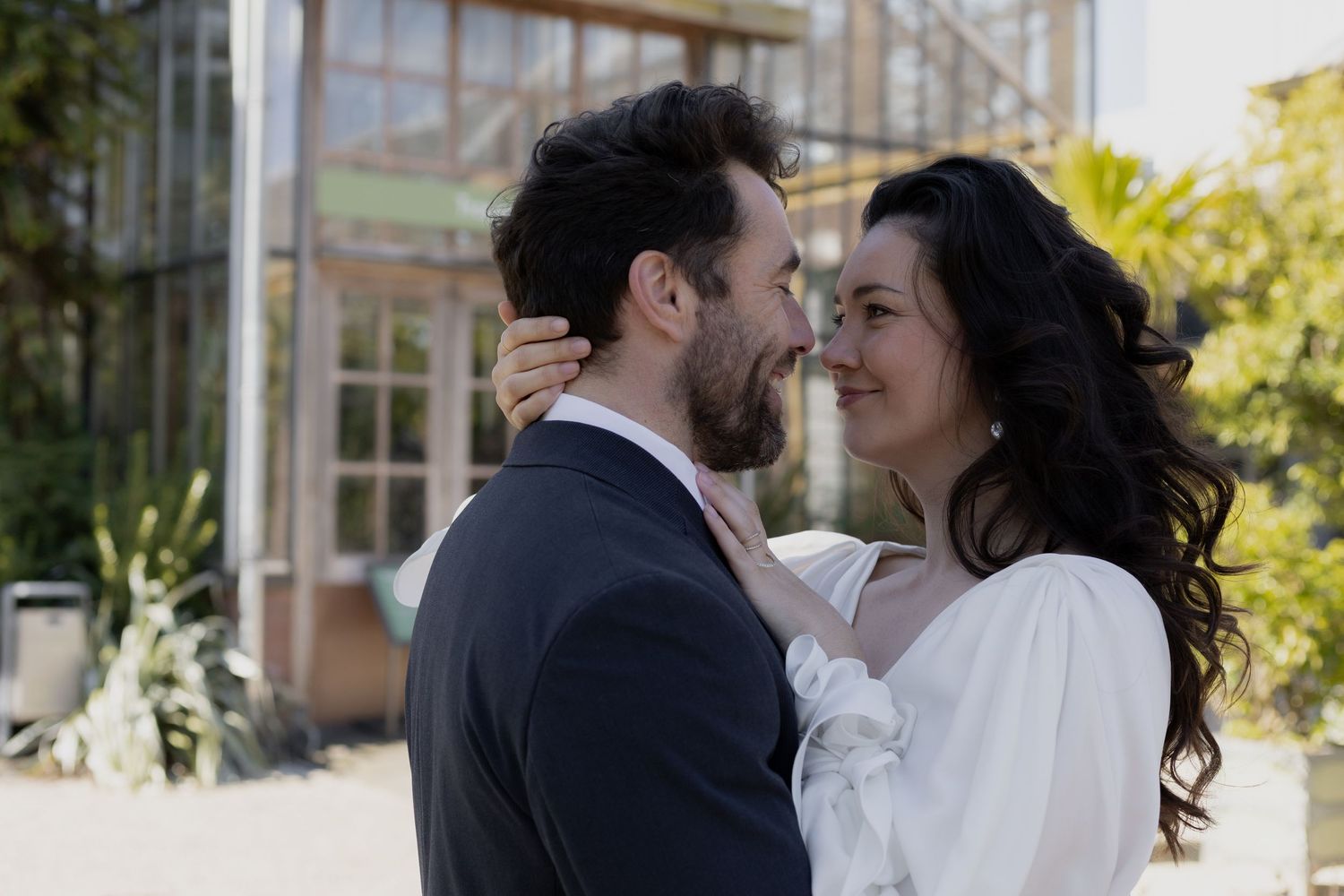 Tender moment between a couple during what appears to be a first look at a wedding.