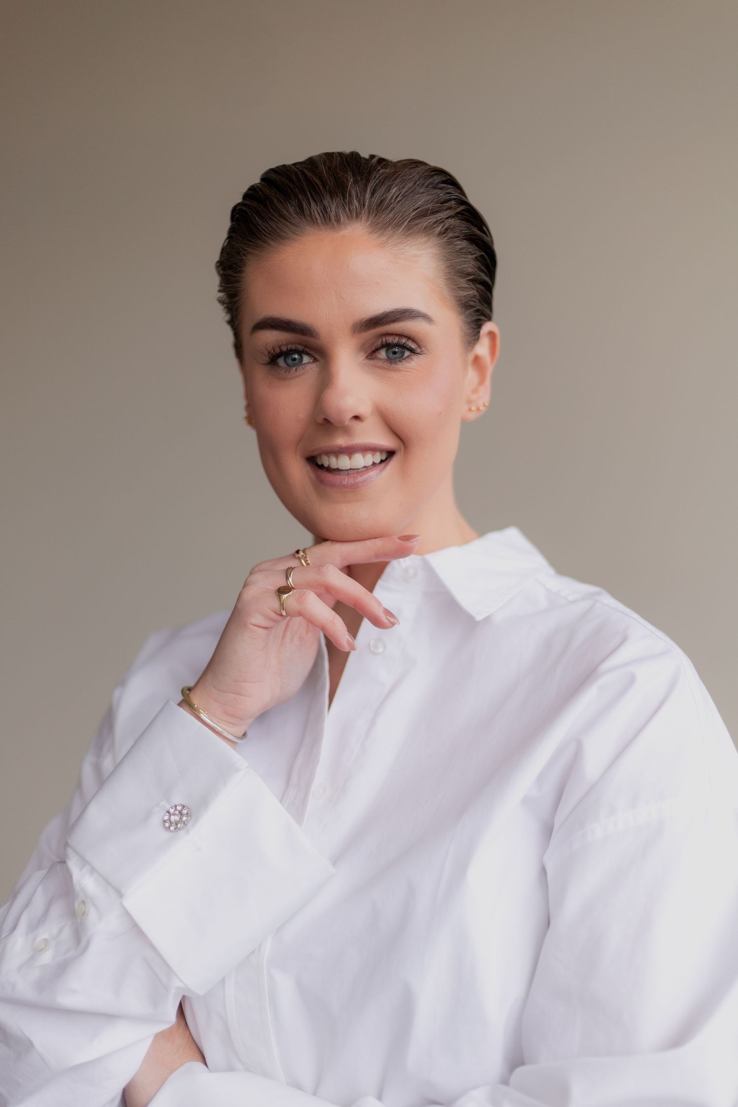 Professional portrait series showing person in crisp white button-down shirt against neutral background with joyful expressions.