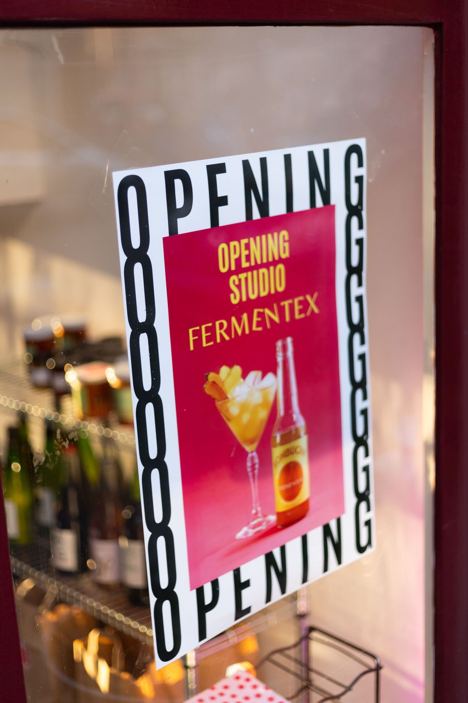 Red signage displaying 'OPENING' and 'FERMENTEX' text in a retail space.