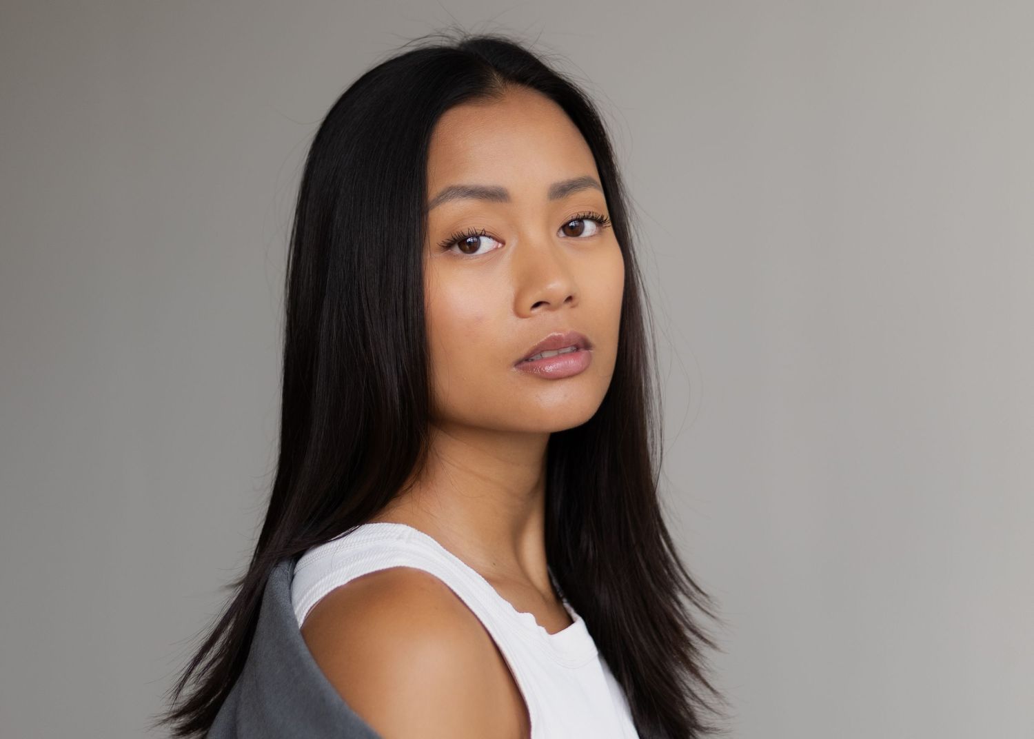 Close up portrait with soft lighting against a neutral background.