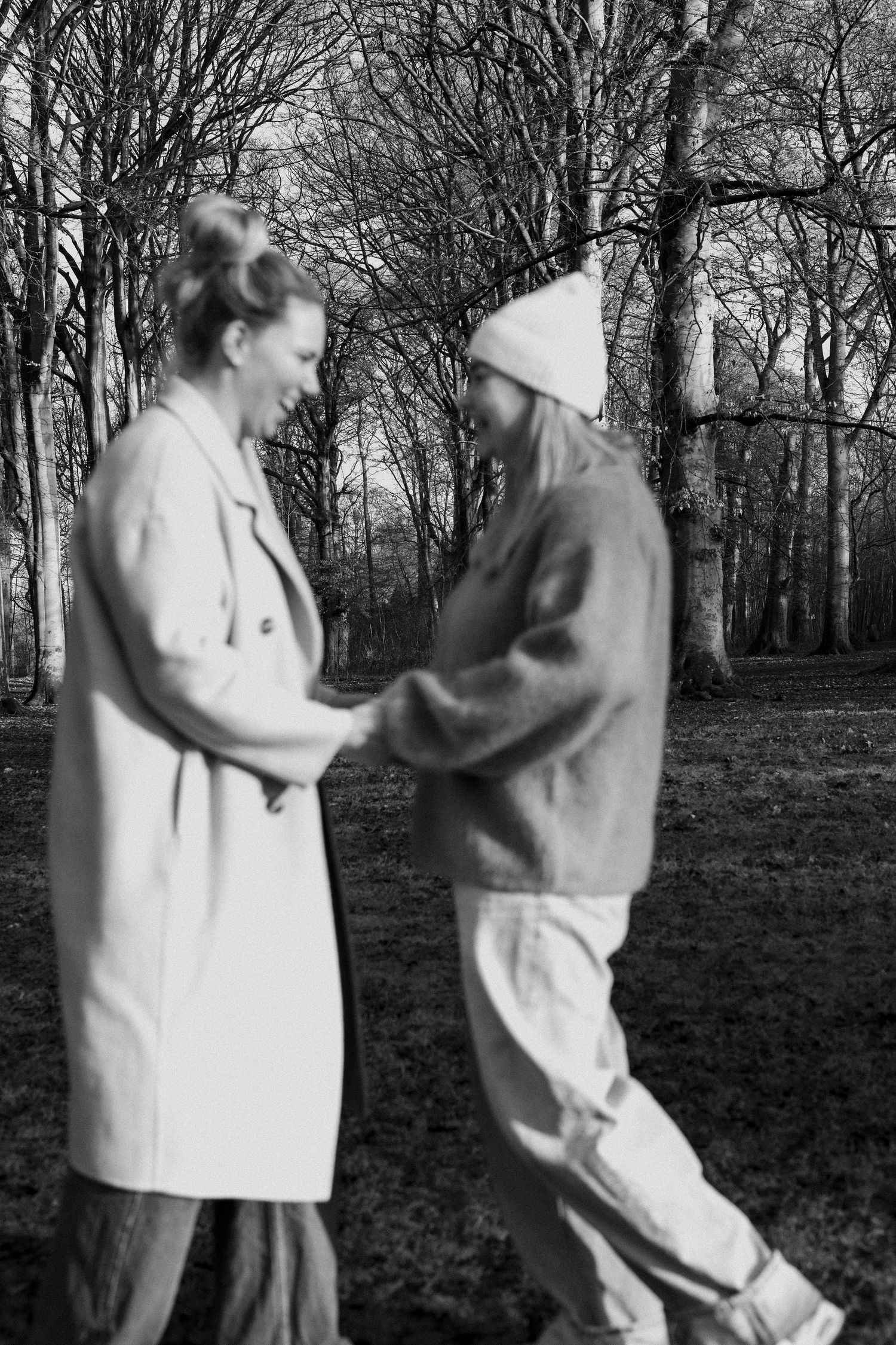 A sequence of black and white photos showing two people in light colored clothing dancing together outdoors among trees.