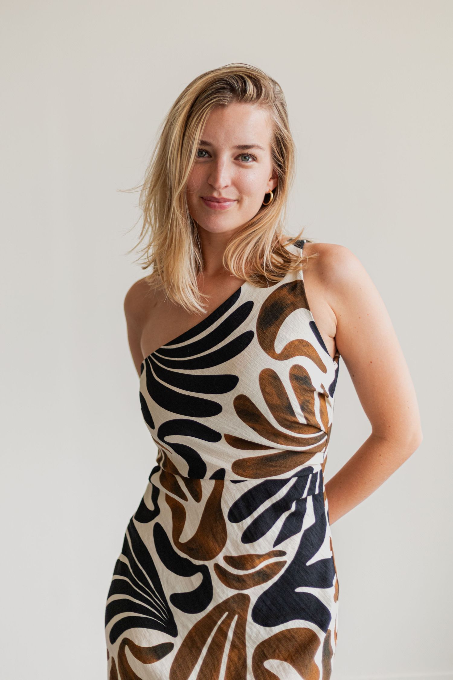 Fashion shots showing a brown and black patterned sleeveless dress against light background.