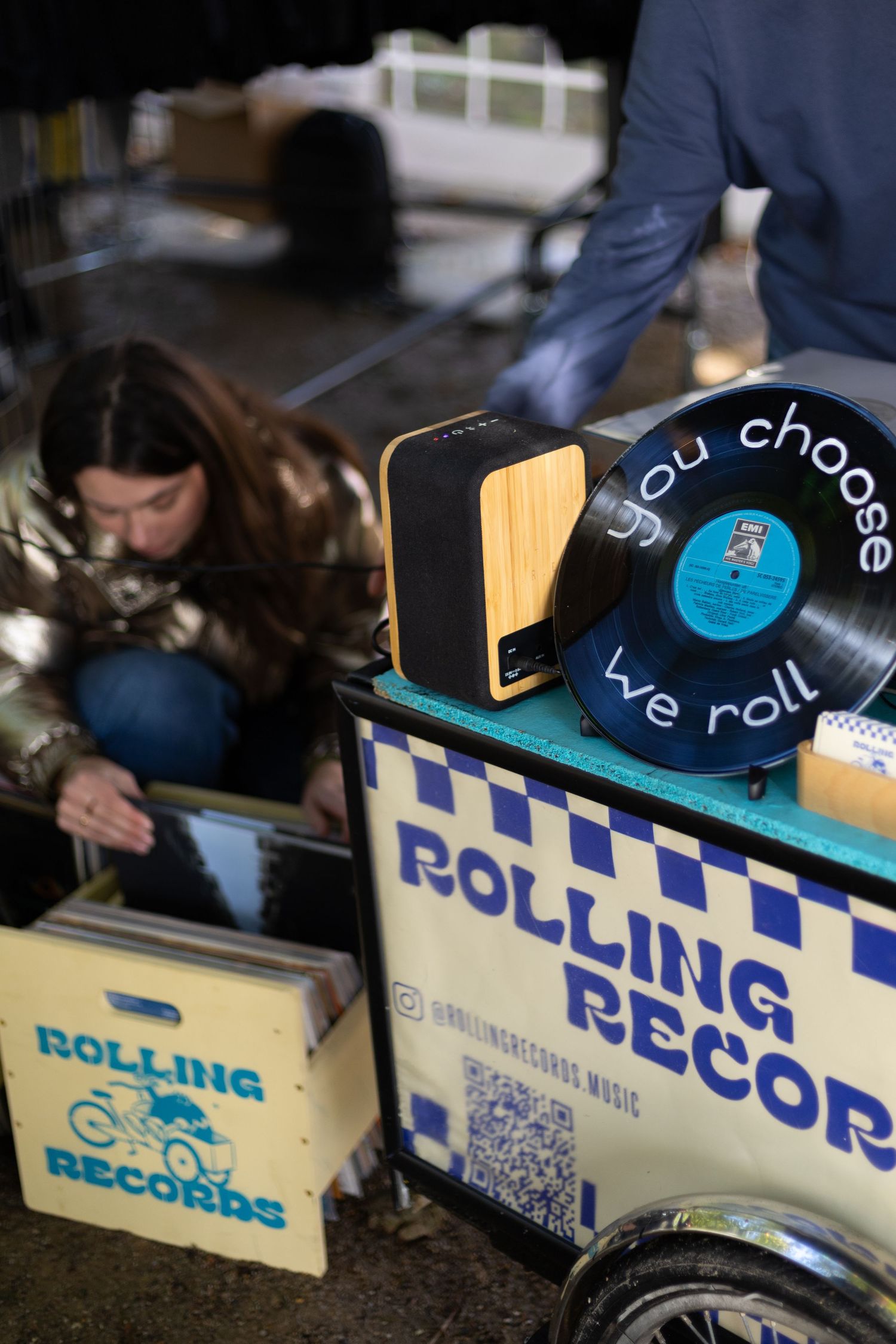 Rolling Records mobile shop display featuring vinyl records and wooden accessories.