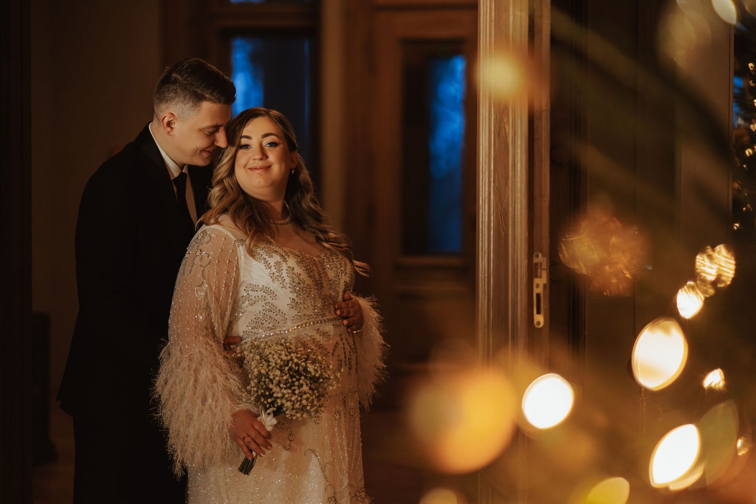 Couple shares tender moments in a warmly lit indoor venue with romantic ambiance.