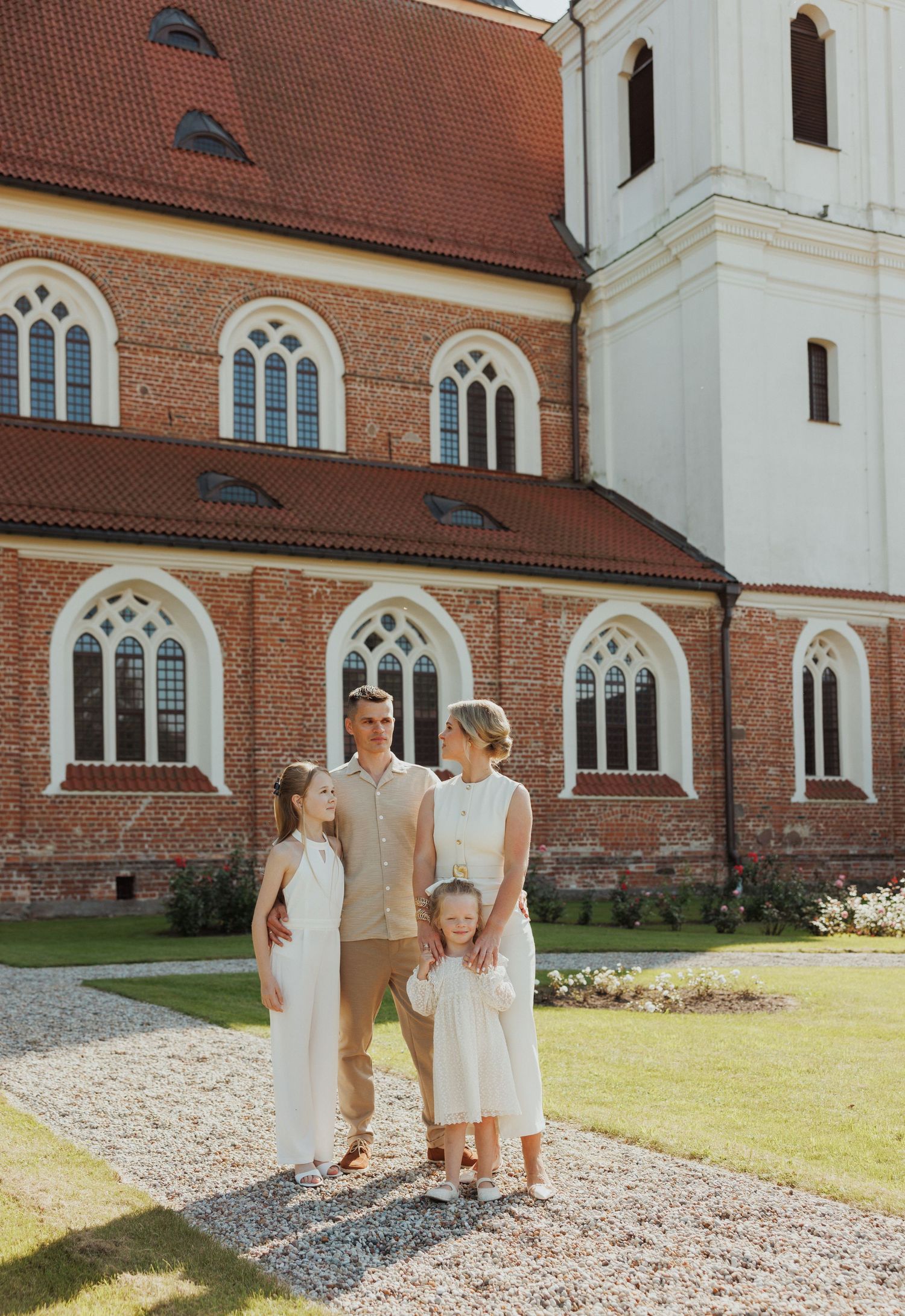 Group walking together outside a historic brick church building with Gothic windows.