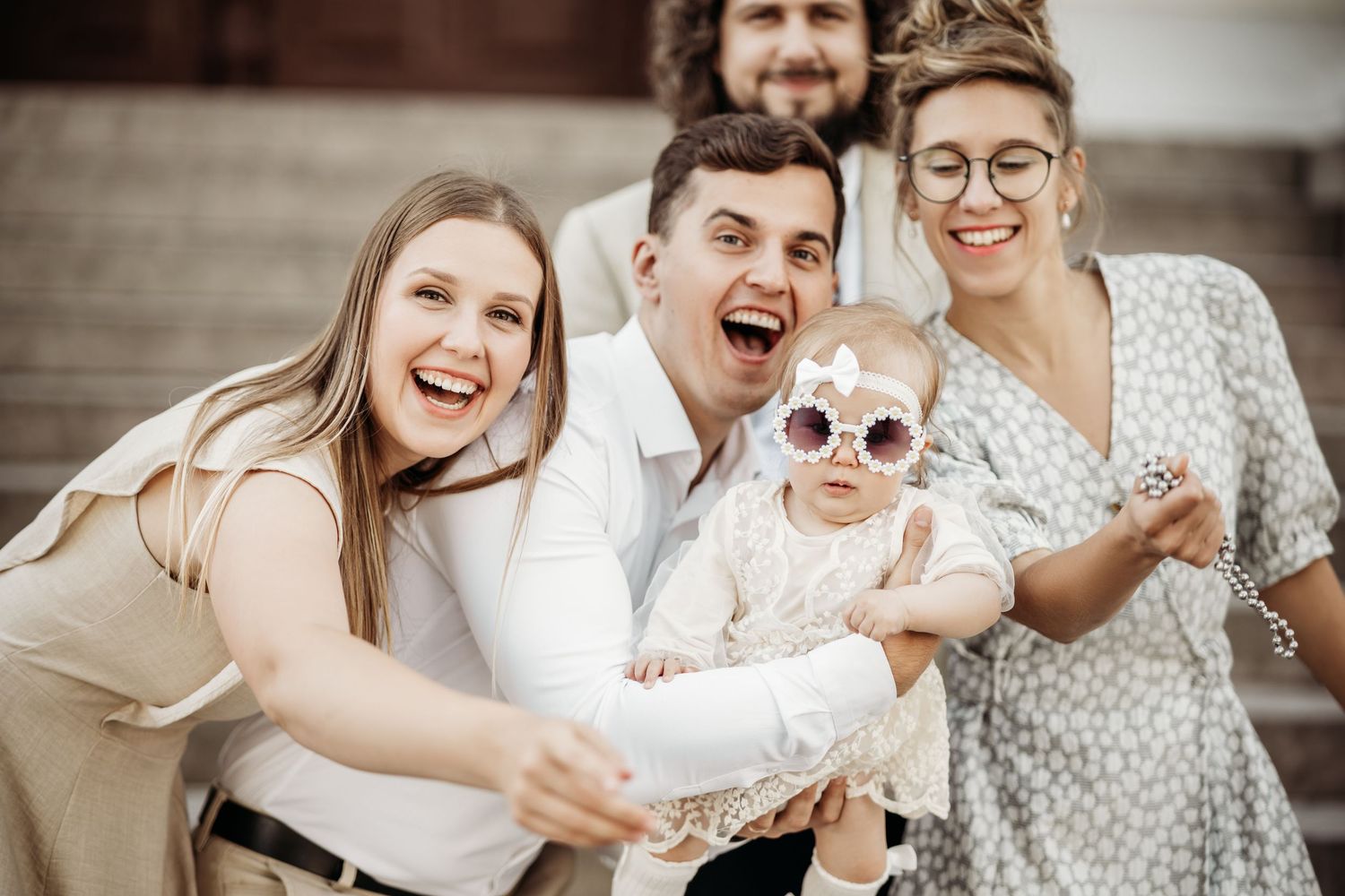 People celebrating together at a casual outdoor party with joyful expressions.