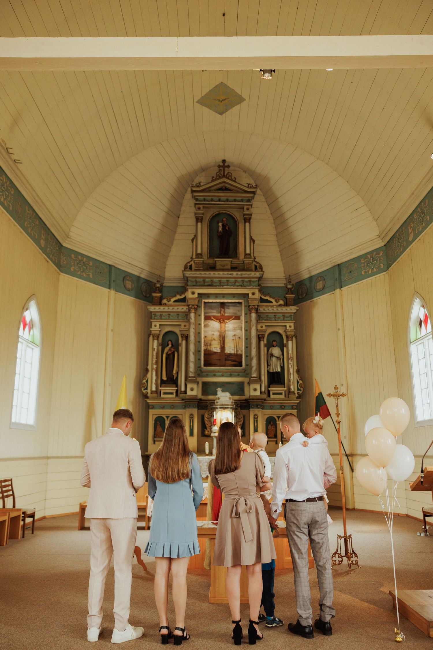 Interior view of a historic wooden church with white walls and a decorative altar showing multiple angles of the same space.