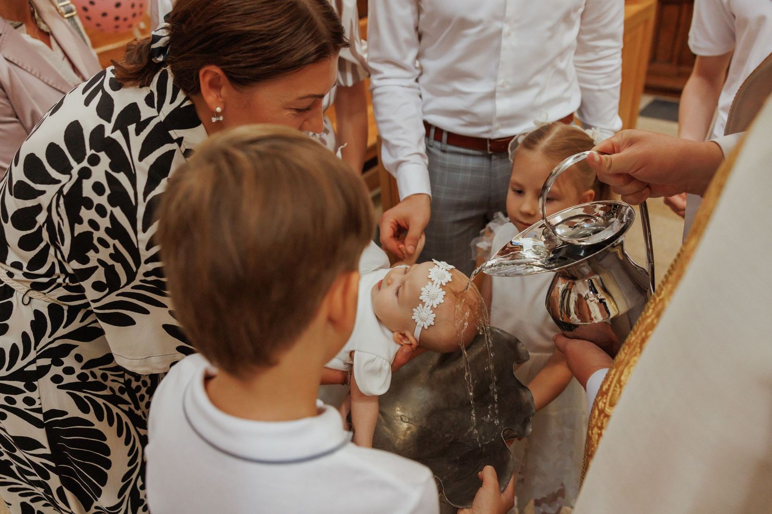 Wedding guests gather around a dessert table at an elegant reception.