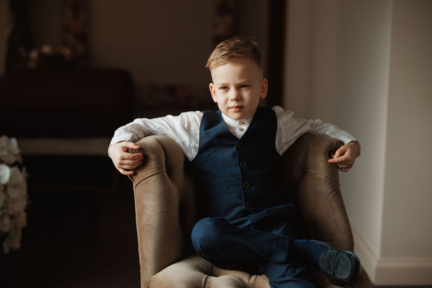 Classic formal portrait in a luxurious interior setting with elegant furniture.