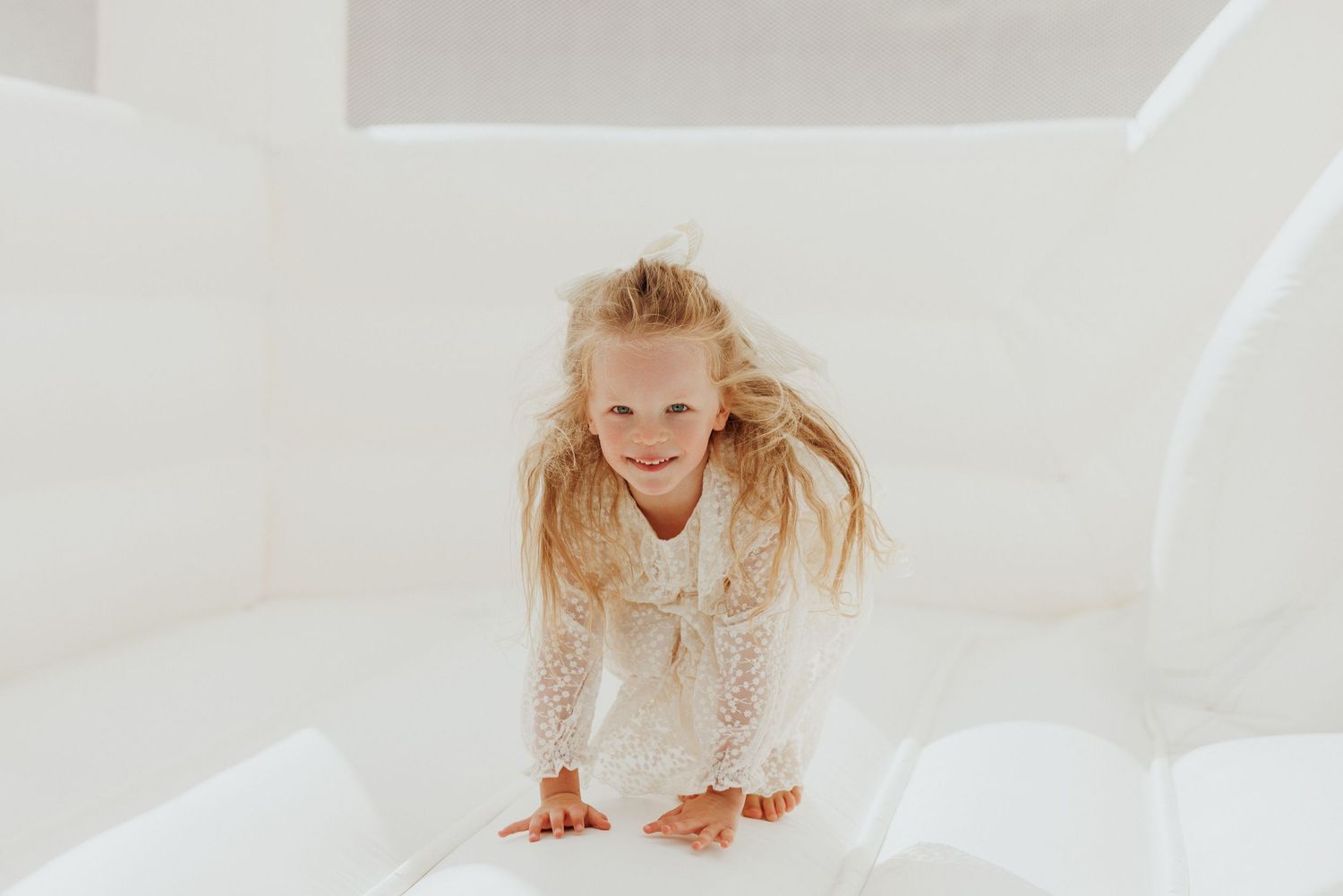 A playful portrait session on a white background with movement and joy.