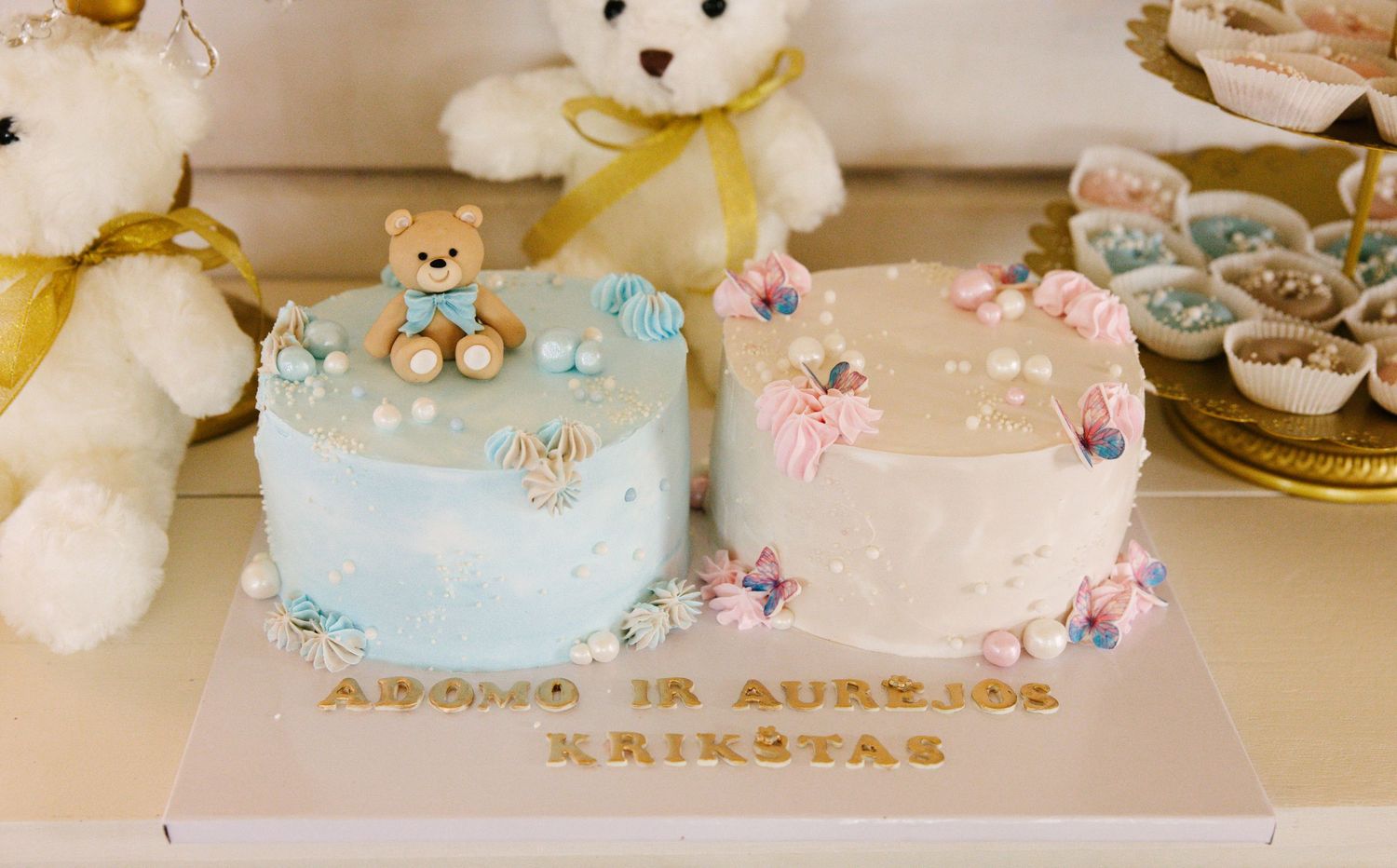 Two small celebration cakes decorated with teddy bears and flowers in blue and pink tones.