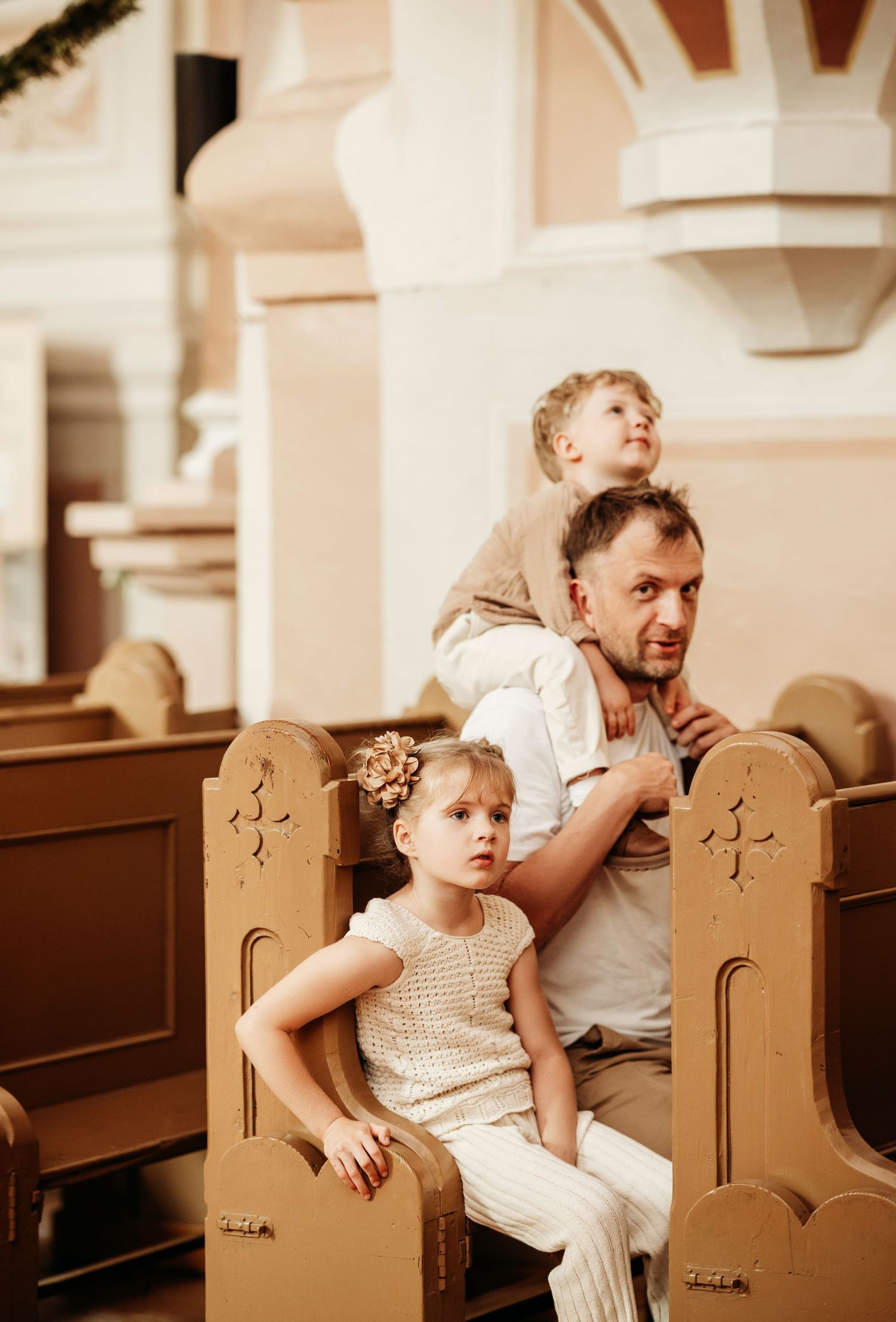 A series of sepia-toned photos showing a parent and child sitting together in a church pew.