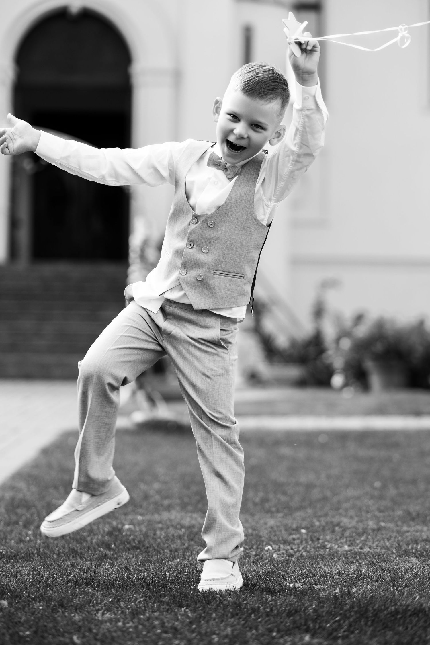 Black and white photo sequence showing playful movement of small feet jumping and running on grass.